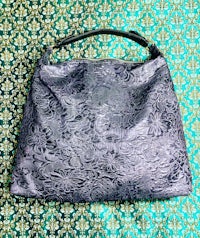 a handbag with a floral pattern on it